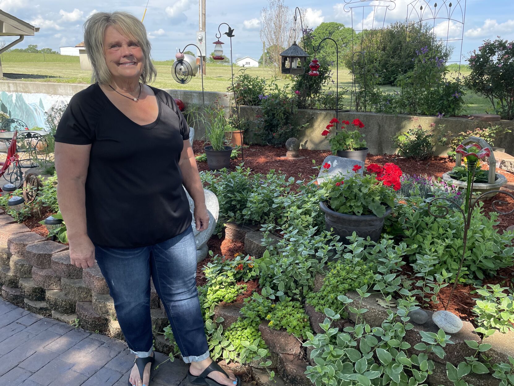 Norma Bledsoe at her flower garden
